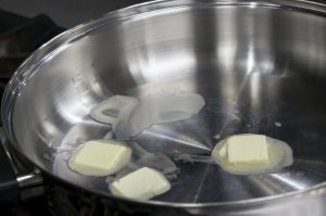 butter melting in a pan on stove