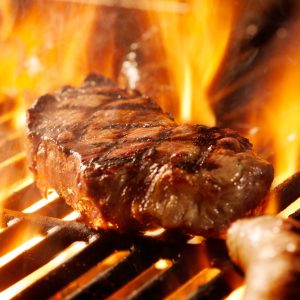 Steak flaming on grill