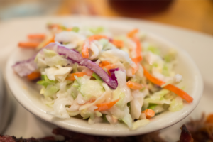 Small bowl of coleslaw on a plate